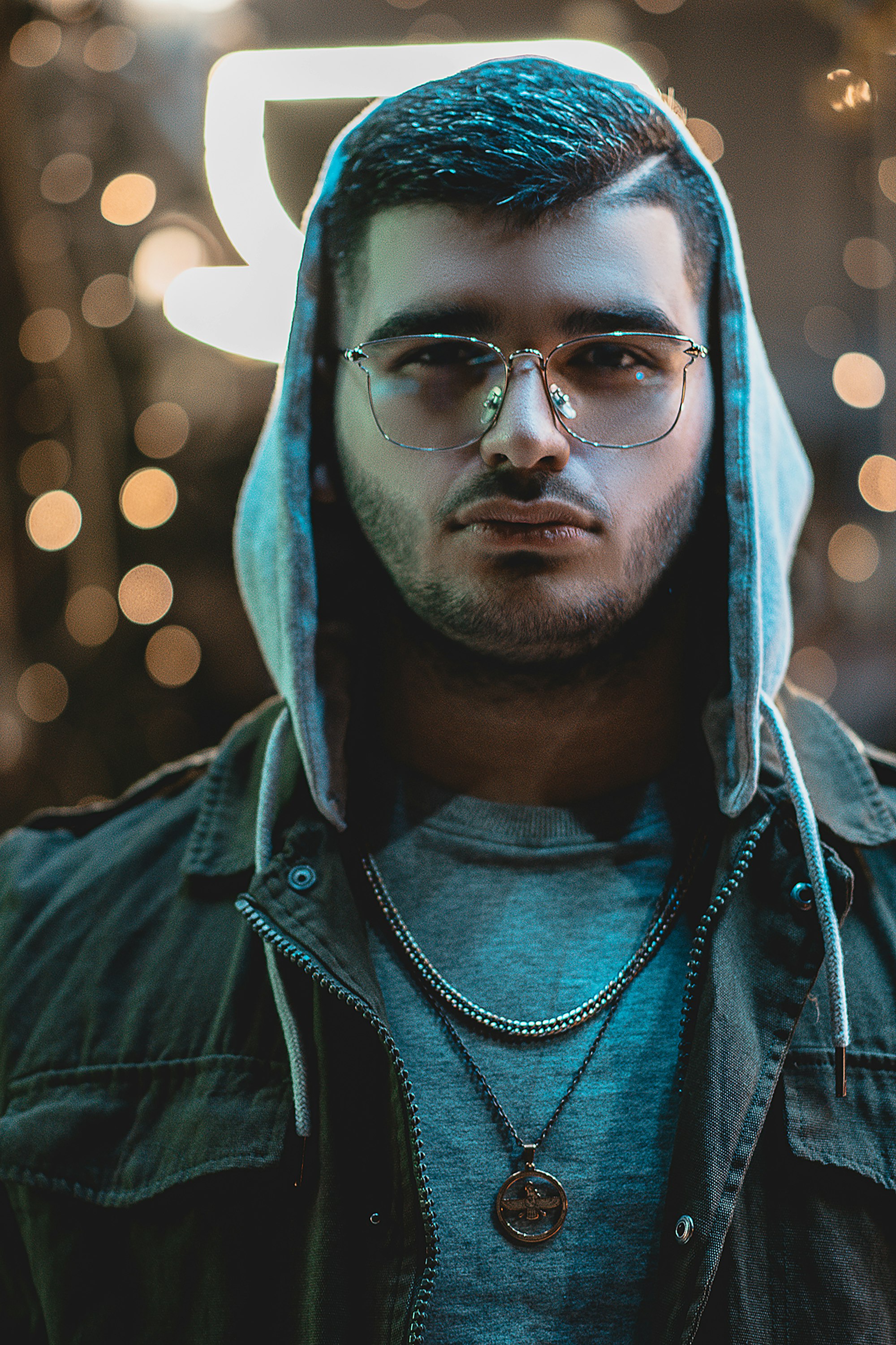 man in blue hoodie wearing black framed eyeglasses